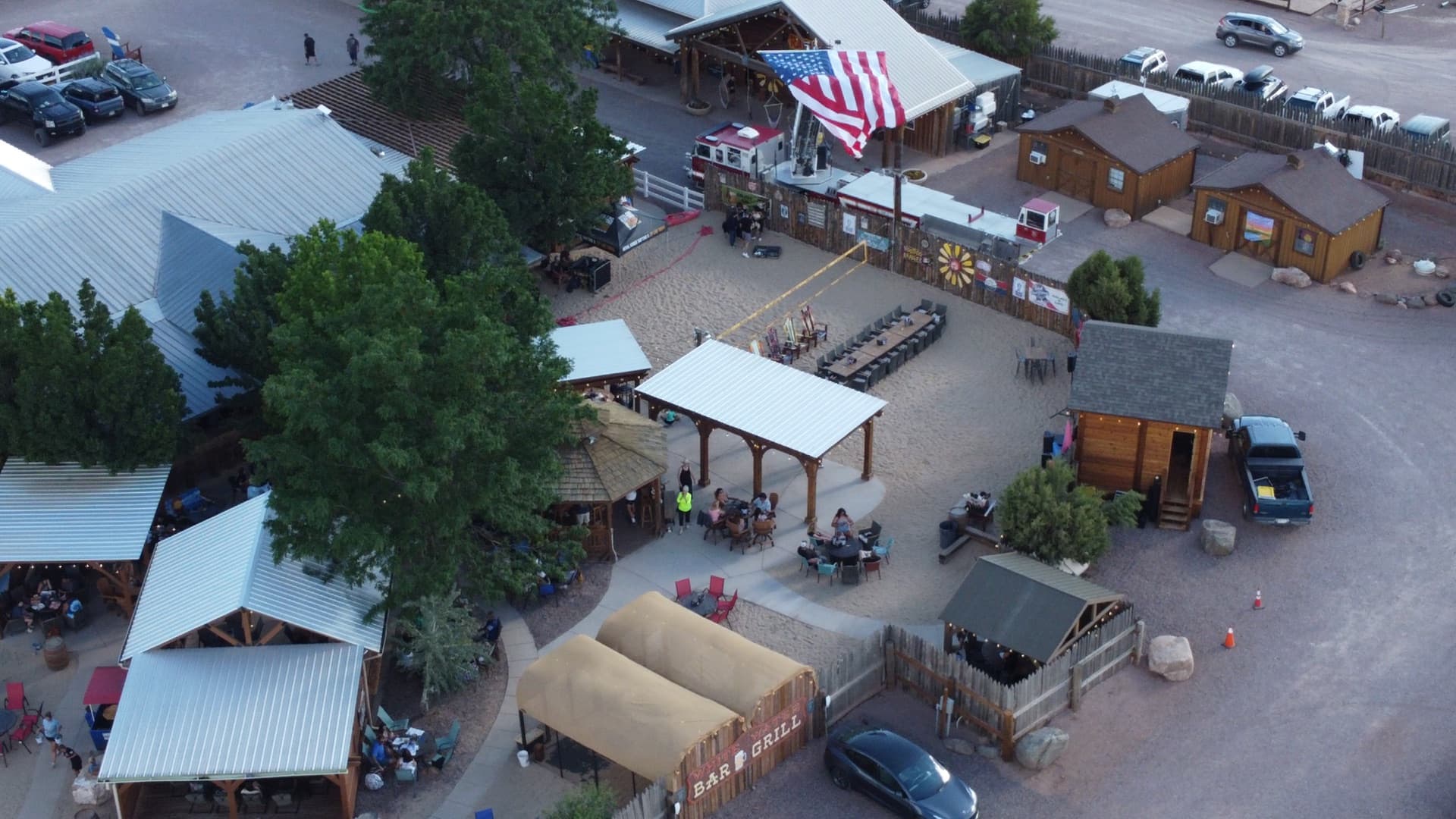 Aerial showing the bar rooftop, outdoor grounds, and the surrounding canyon terrain.